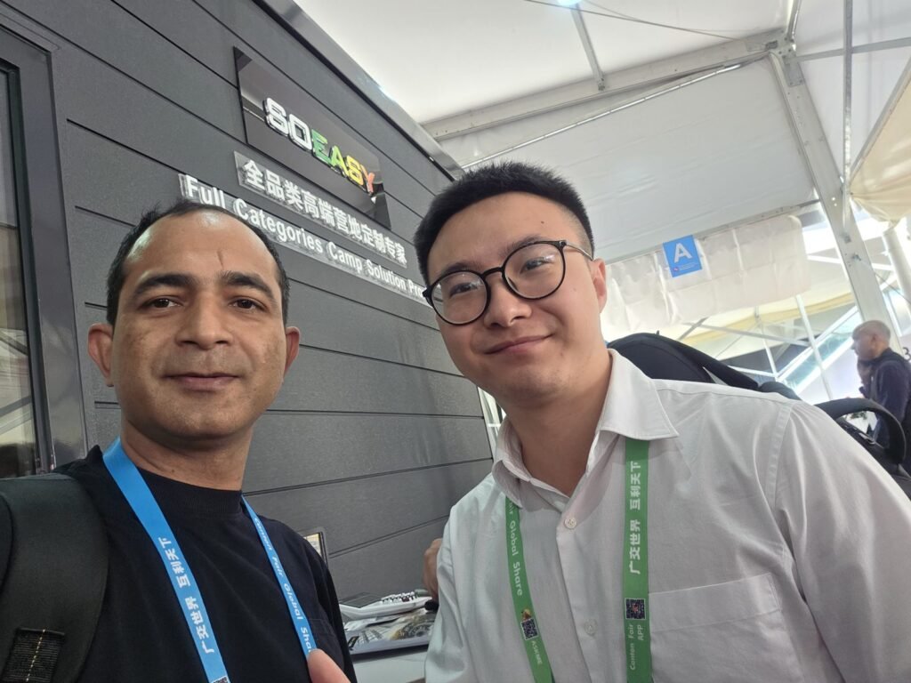 Max with an exhibitor at a camp and cabin solutions booth at the Canton Fair, Guangzhou