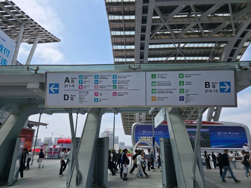 Direction signs at the Canton Fair Complex showing product categories for Area A halls 1 to 8, Area D halls 17 to 20 and Area B halls 9 to 13