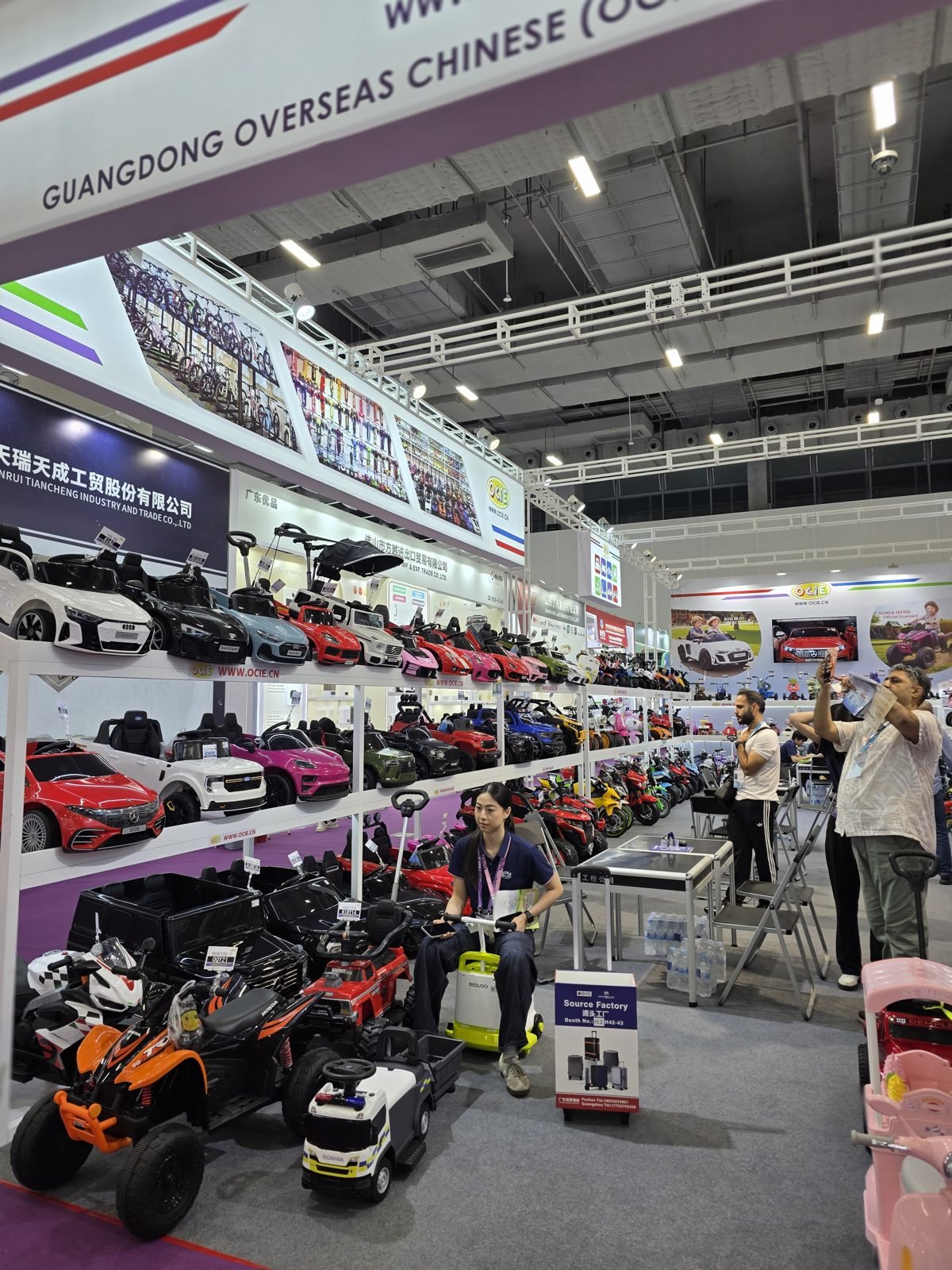 Shelves of kids electric ride-on cars and bikes at a Canton Fair exhibitor booth