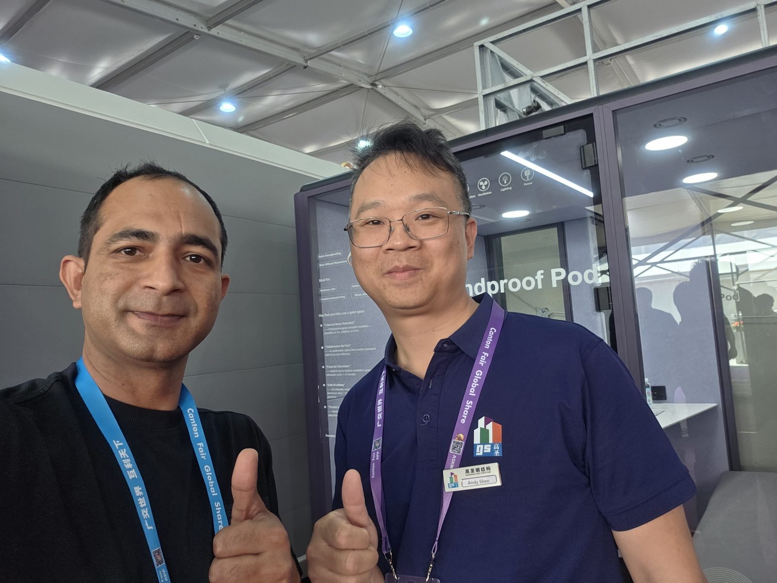 Max with a steel structure manufacturer beside their soundproof office pods at the Canton Fair, Guangzhou